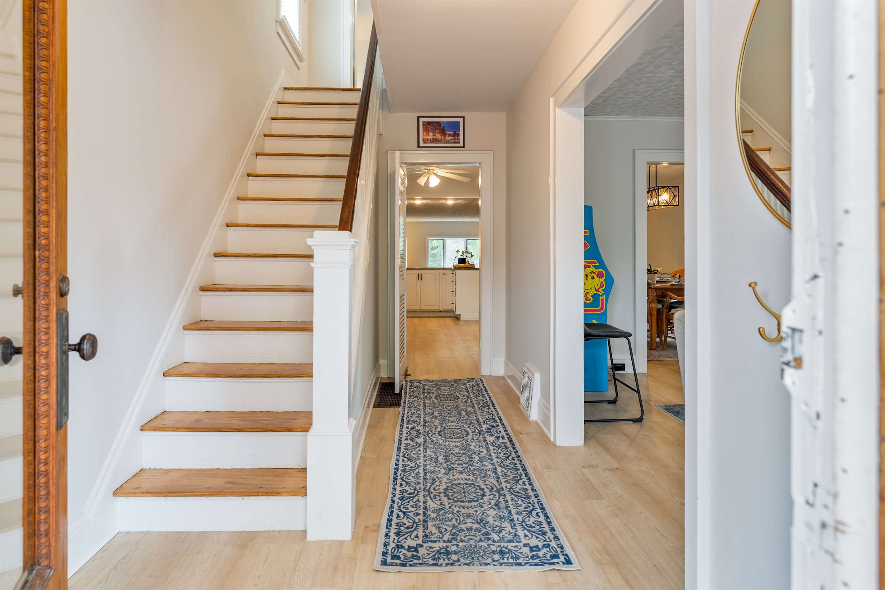 Step into a warm and inviting entryway leading you straight to a beautifully updated kitchen.