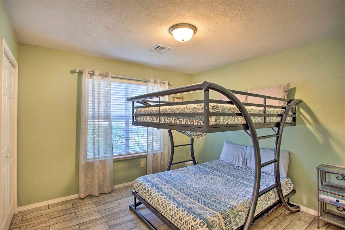 Green bedroom with full over full bunk bed