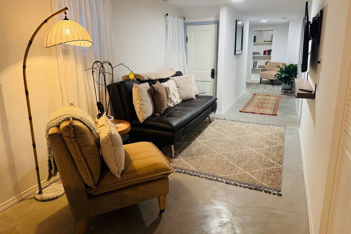 Second cozy living room with leather sofa that easily converts into a comfortable bed  — perfect for additional guests. Fresh linens and bedding are provided for easy setup.