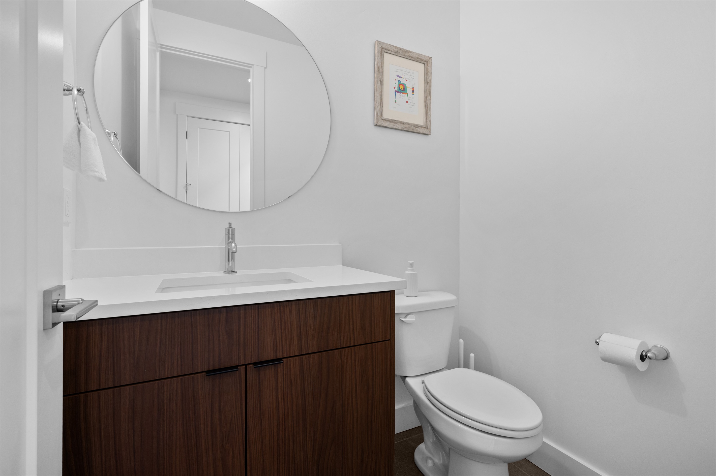 Main-level half bath with modern vanity and clean contemporary design.