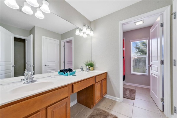 Upstairs hall bath with two sinks and separate tub/shower area 