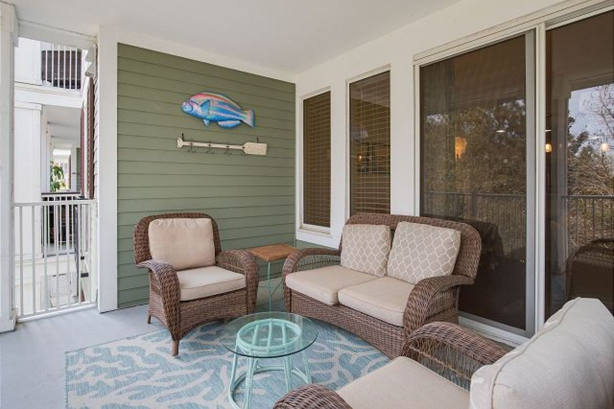 Balcony wicker seating beside the sliding doors from the living room