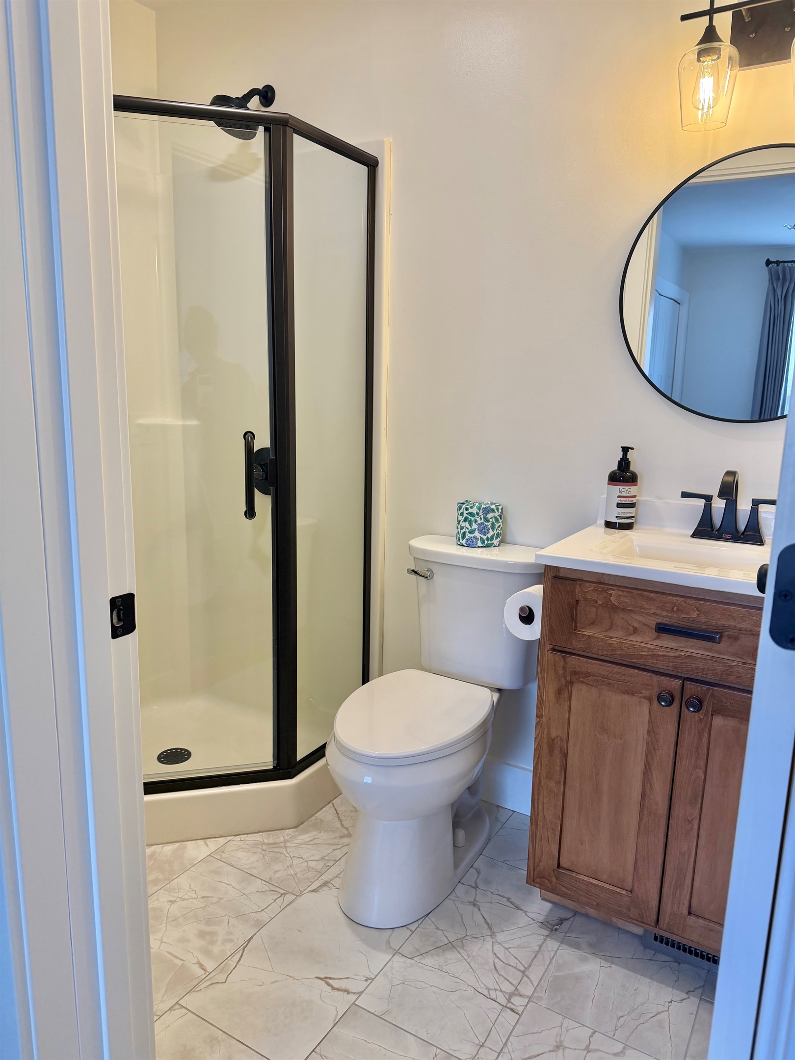 Updated ¾ bathroom featuring a walk-in shower and custom cabinetry