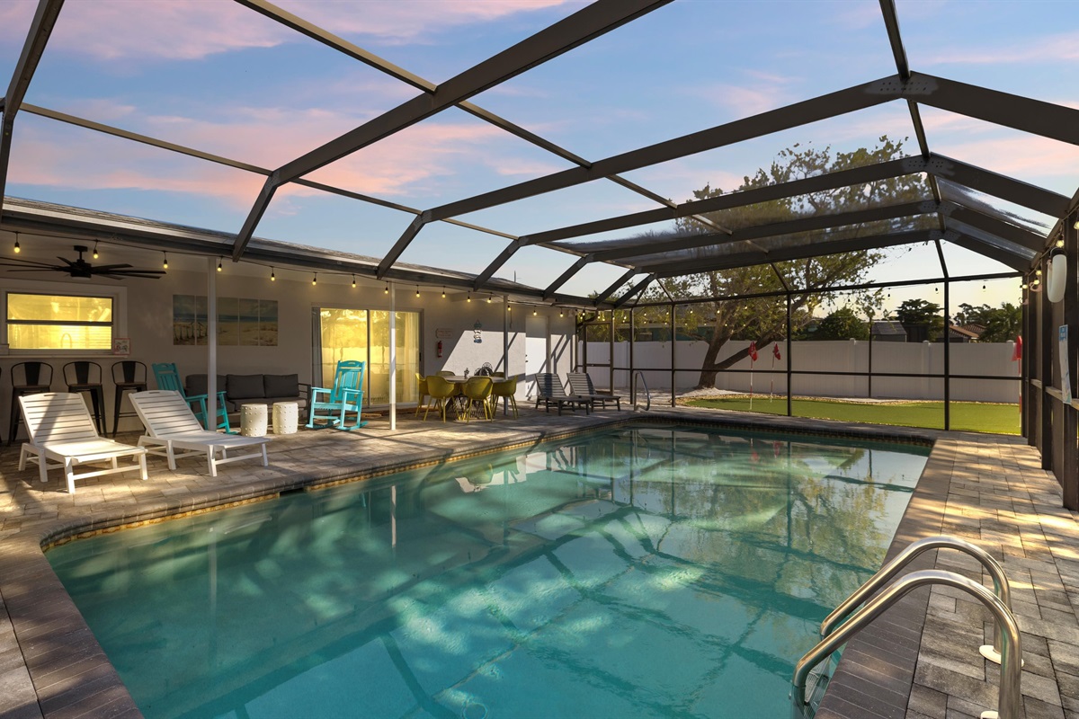 A backyard retreat with a crystal pool, tropical vibes, and restful poolside chairs.