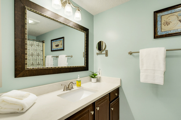 The second full bath offers a spacious vanity and thoughtful touches including plush Pottery Barn terry, Terra Pure bath amenities, and Mrs. Meyer’s hand soap.