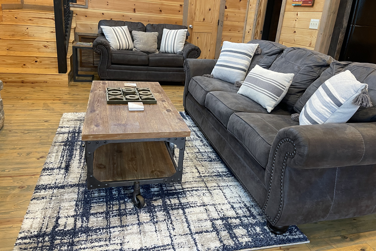 Relax with friends and family the comfortable downstairs living room and fireplace with vaulted ceilings that give you a true "open concept". 