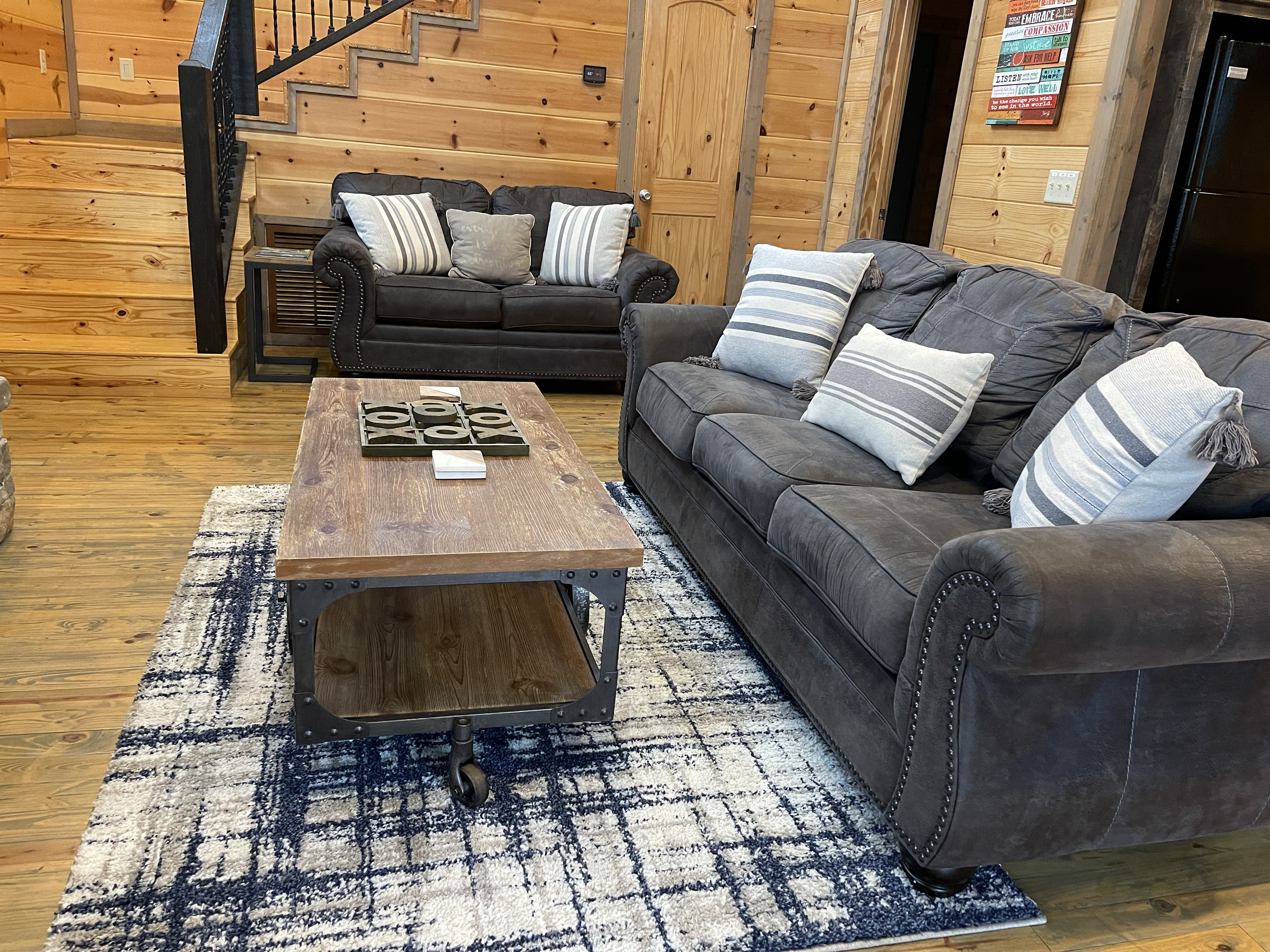 Relax with friends and family the comfortable downstairs living room and fireplace with vaulted ceilings that give you a true "open concept". 