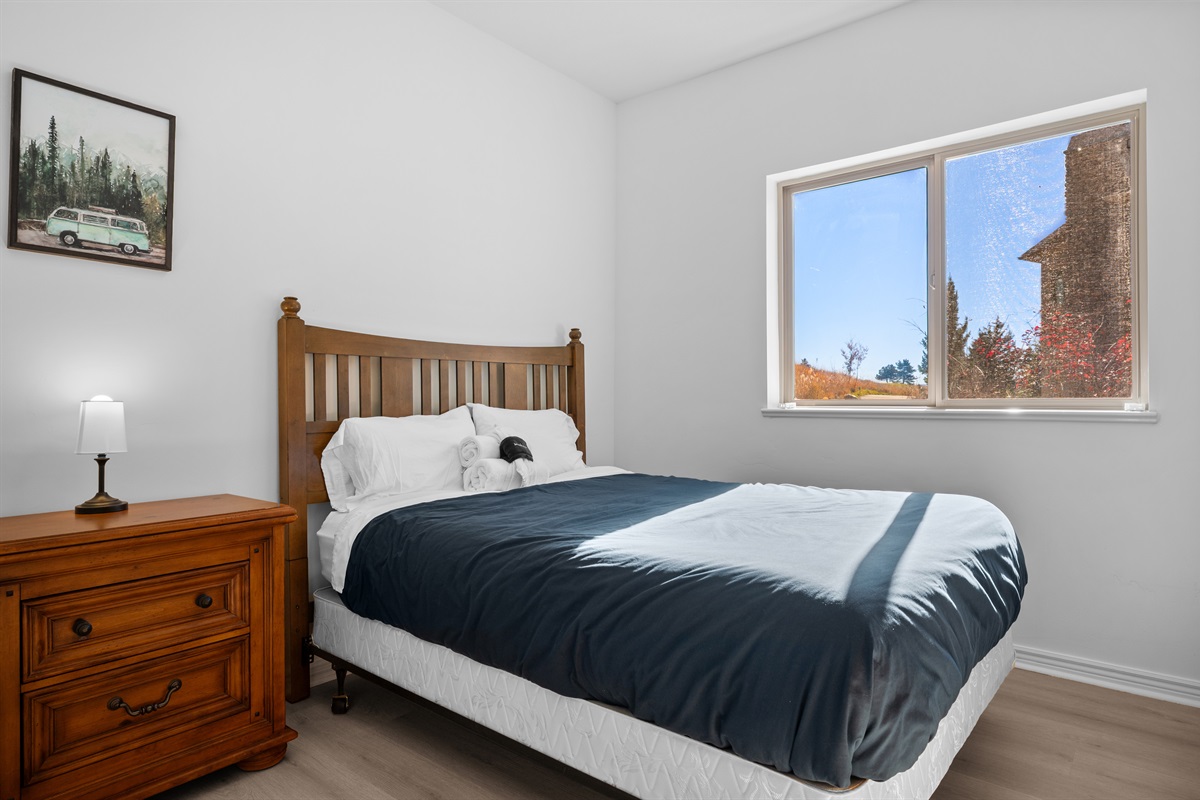 The fourth bedroom offers plenty of natural light and is adorned with charming decor.