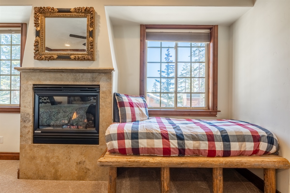 A cozy daybed and fireplace create a flexible lounge or reading nook within the Moose's primary suite.