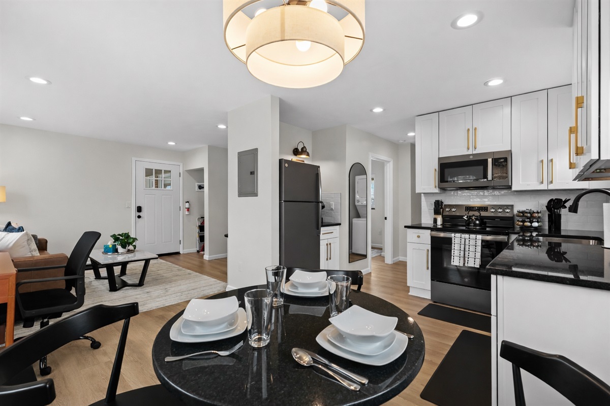 Modern, fully equipped kitchen with sleek appliances, stylish cabinetry, and a cozy dining area—perfect for cooking, dining in, or hosting relaxed meals together.