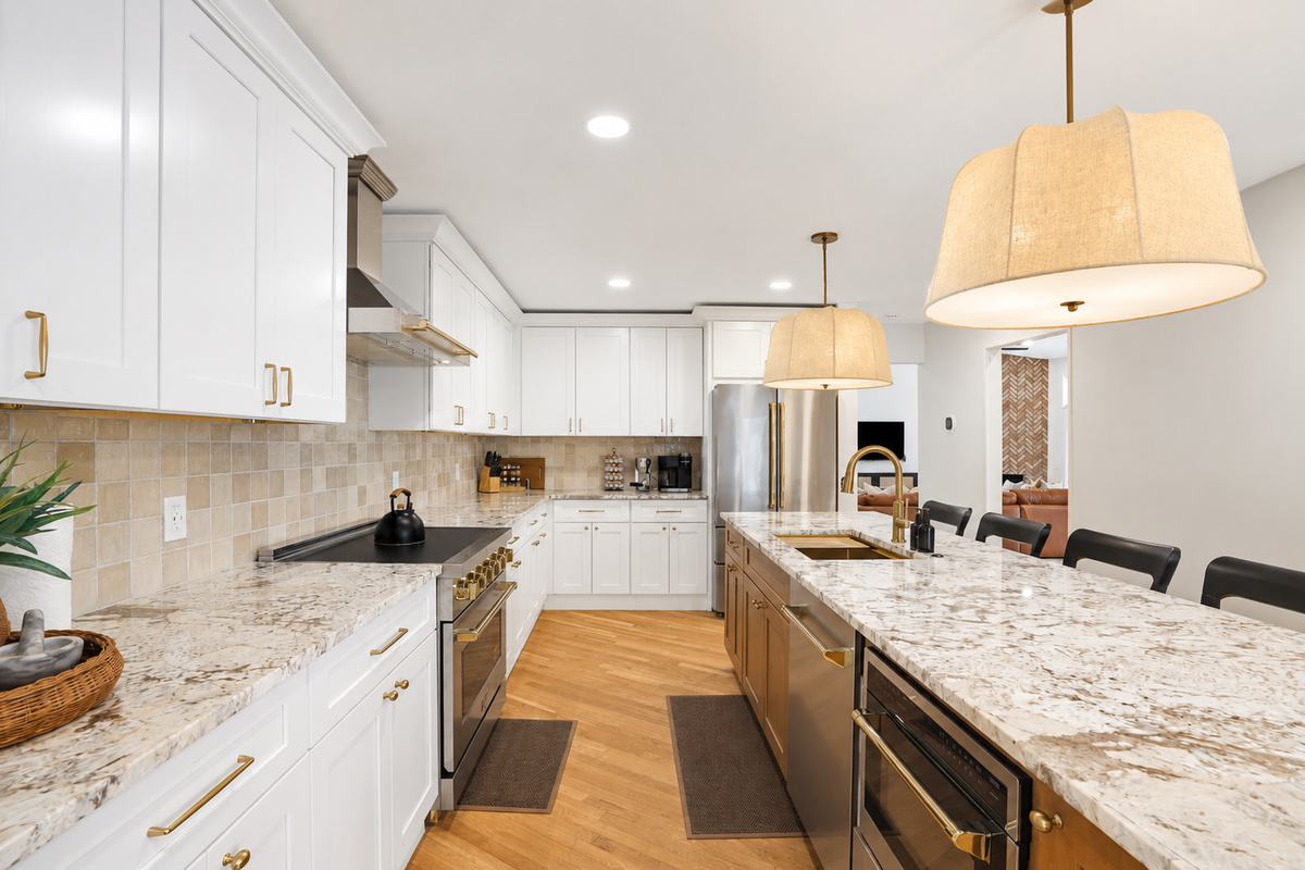 Bright, modern kitchen with quartz countertops, large island, and open layout—perfect for cooking, dining, and entertaining.