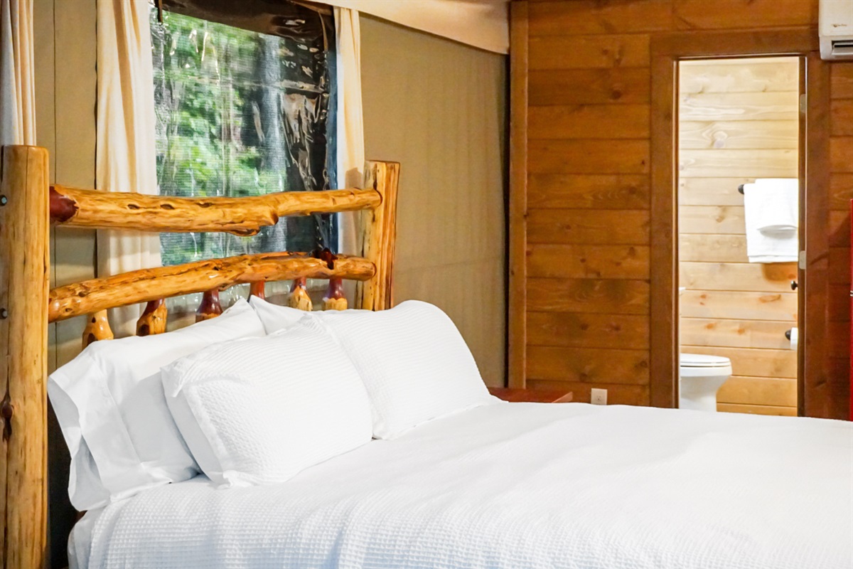 Experience rustic charm with a log bed and nature views from your window!