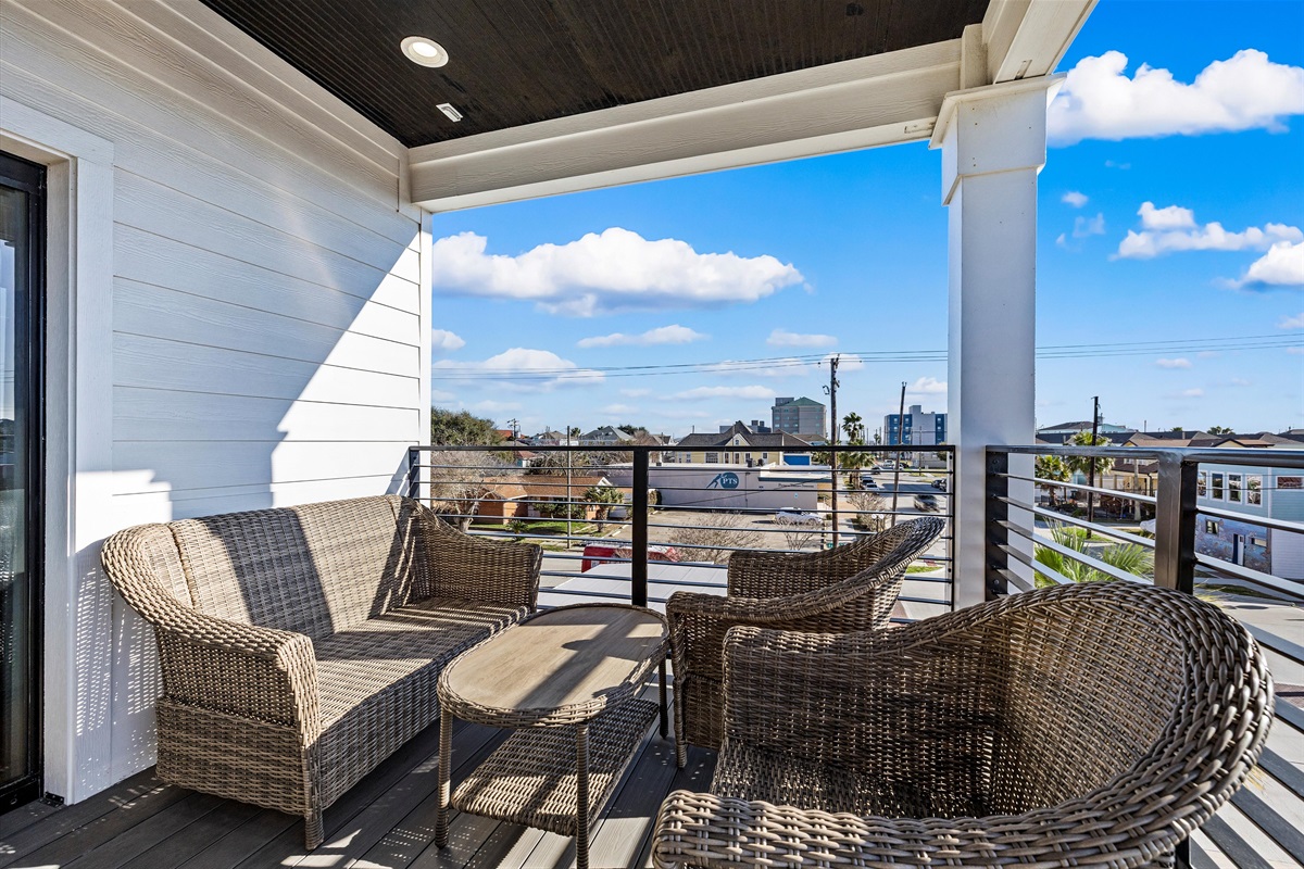Balcony Retreat: Enjoy ocean views from this stylish seating area, perfect for sunset cocktails!