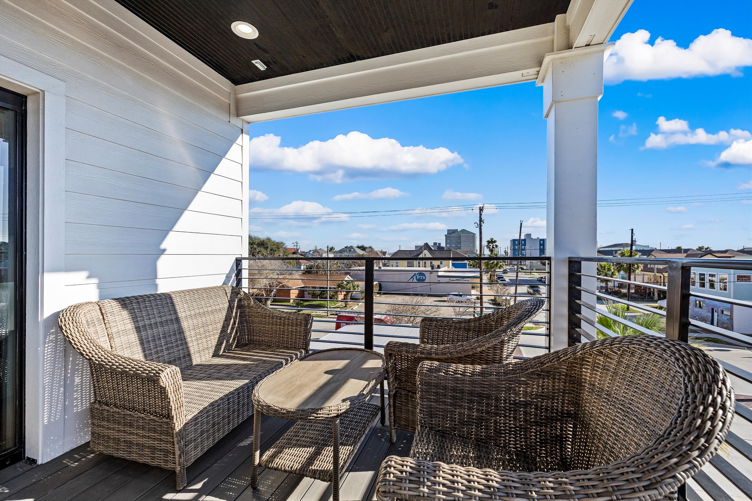 Balcony Retreat: Enjoy ocean views from this stylish seating area, perfect for sunset cocktails!