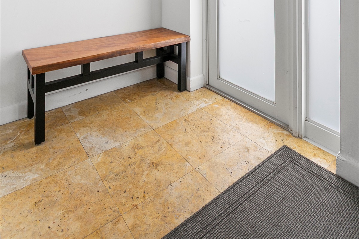 Private entrance foyer with storage space, easily accessible beach gear, and a bench
