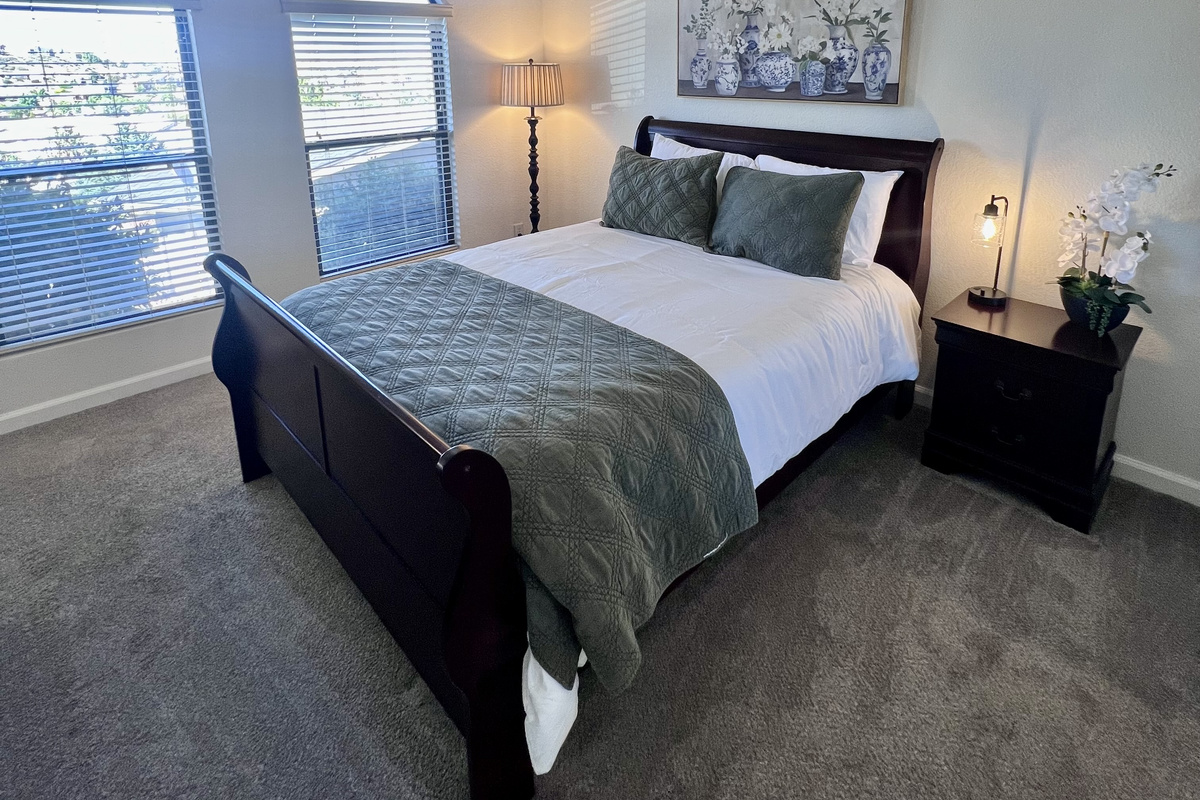 Enjoy a peaceful night's sleep in the inviting secondary bedroom, complete with a plush queen-size bed and soft linens.  Keep your belongings organized and easily accessible with the spacious closet, convenient drawers, and bedside nightstand.