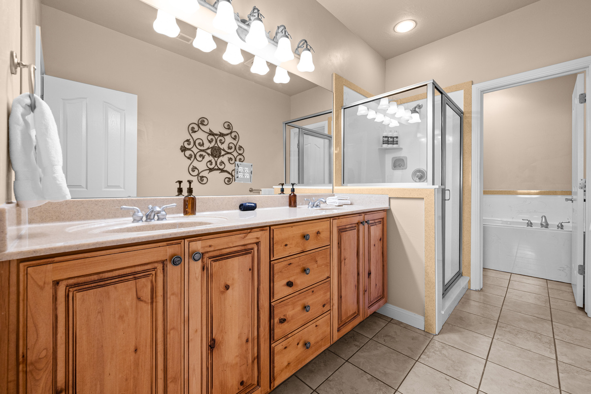 Spa-like primary bathroom with double vanity, walk-in shower, soaking tub, and elegant finishes.