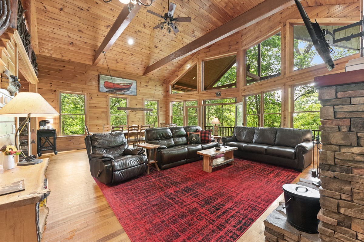 Floor-to-ceiling windows fill the cabin with natural light and forest views.