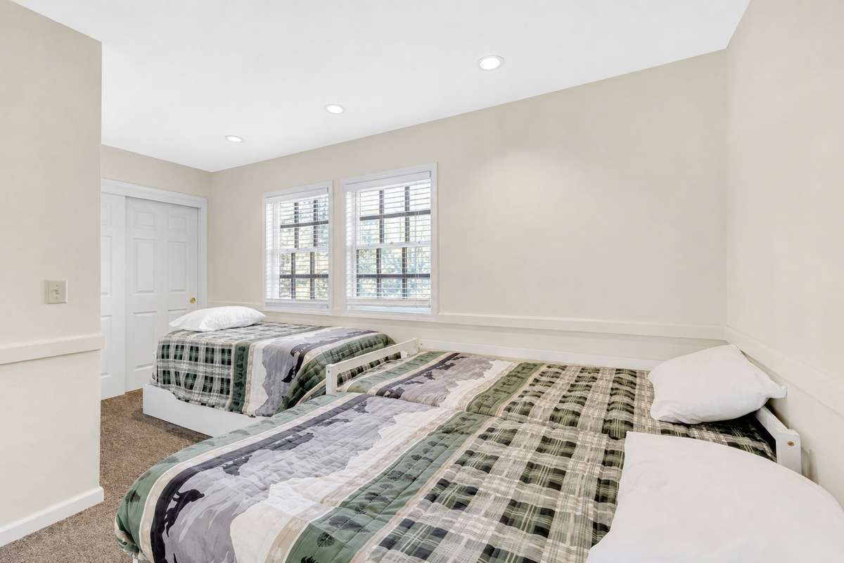 Bedroom 3 with three twin beds and a simple setup for kids, friends, or extra guests.
