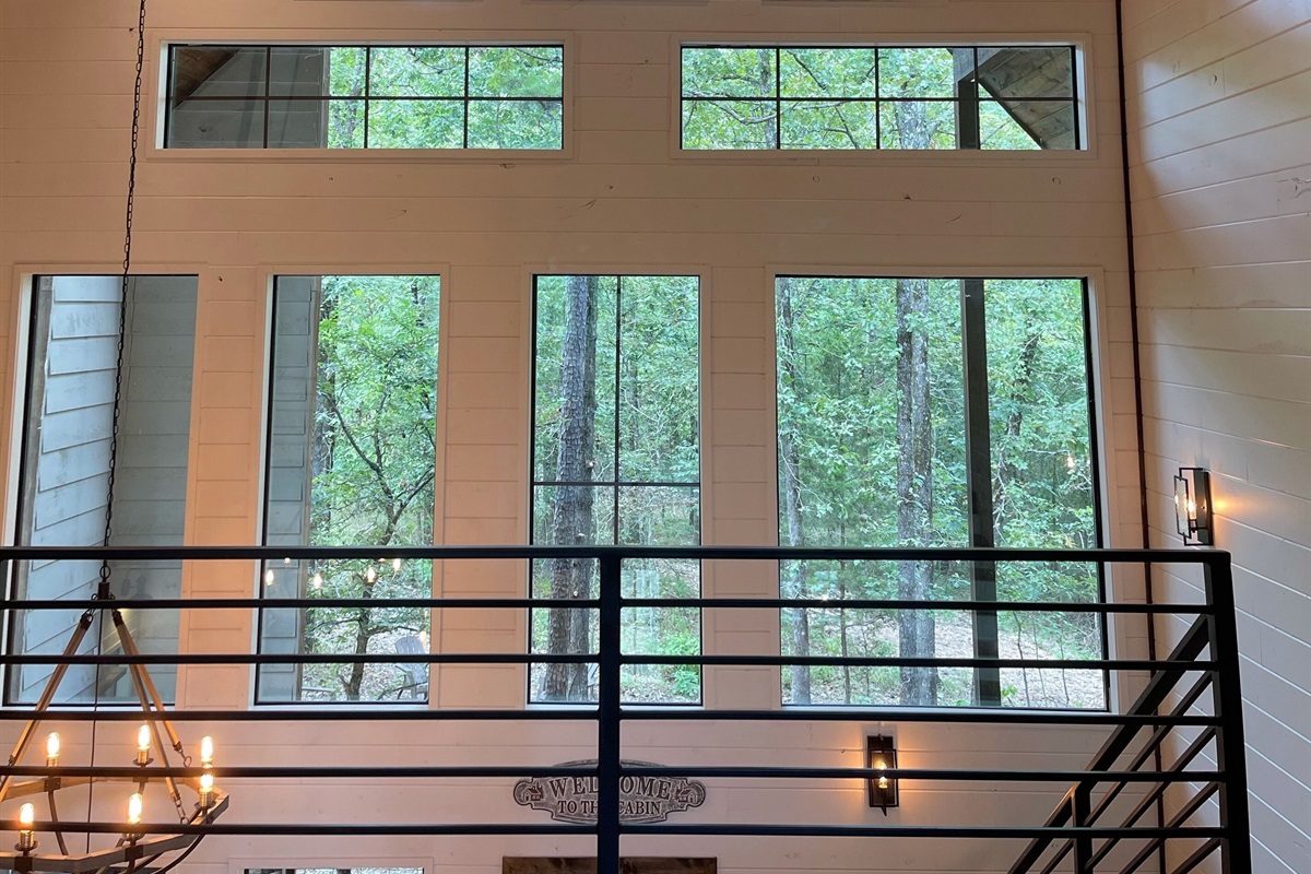Seated on the super comfy new sleeper sofa, over looking the ping pong table in the loft and through the wall of windows towards the Ouachita National Forest.