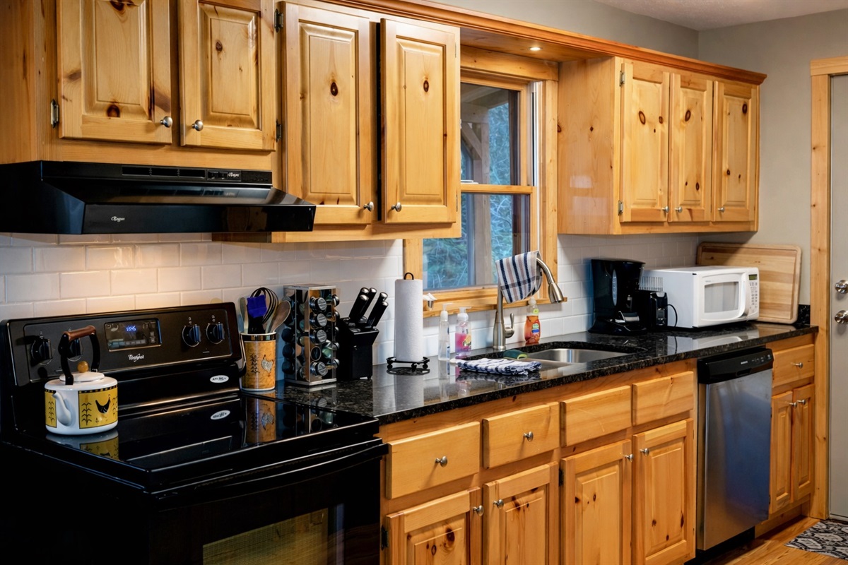 A warm, fully stocked cabin kitchen—perfect for cooking, gathering, and enjoying slow mountain mornings.