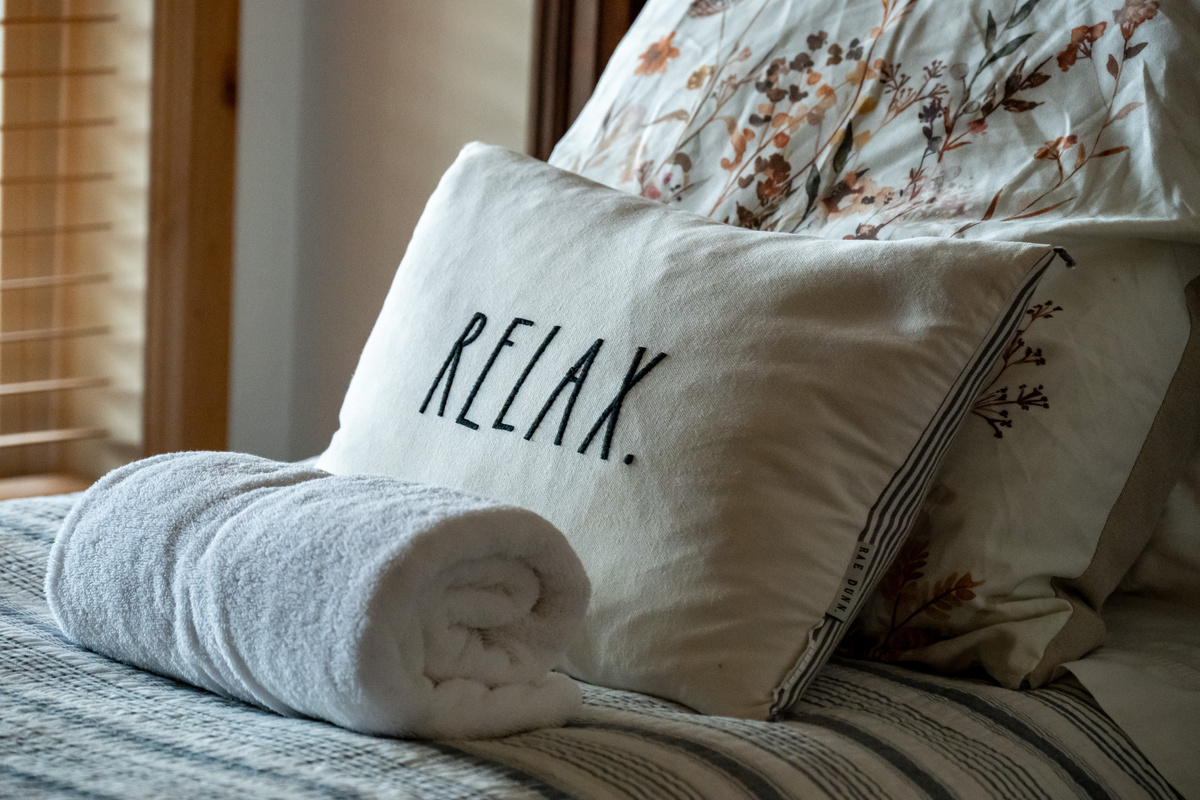 Cozy details and fresh linens create a welcoming place to settle in for the night.