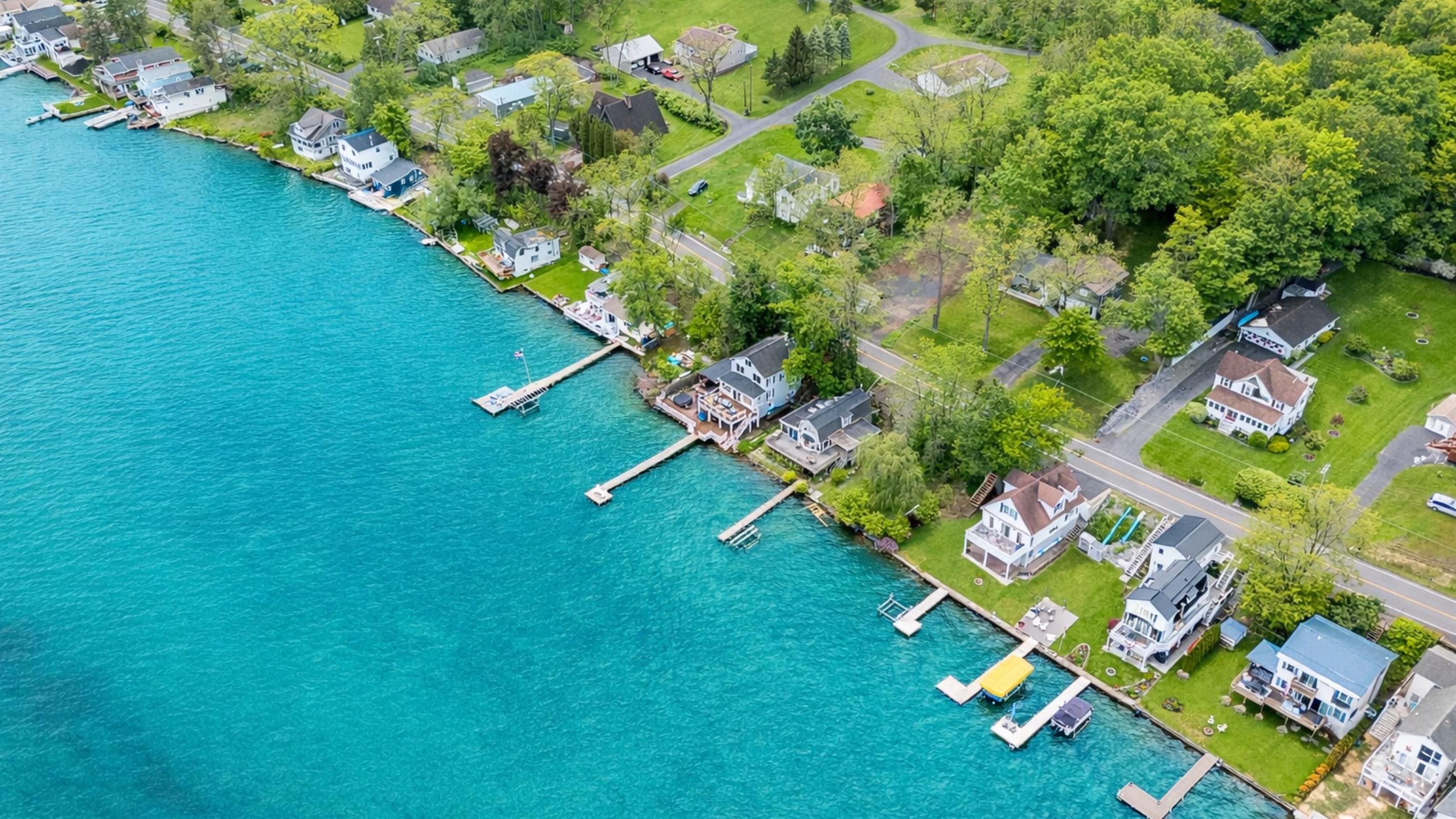 Aerial shot showcasing expansive lakefront entertaining space, hot tub, and private dock for the ultimate getaway 🎯🌊🍹