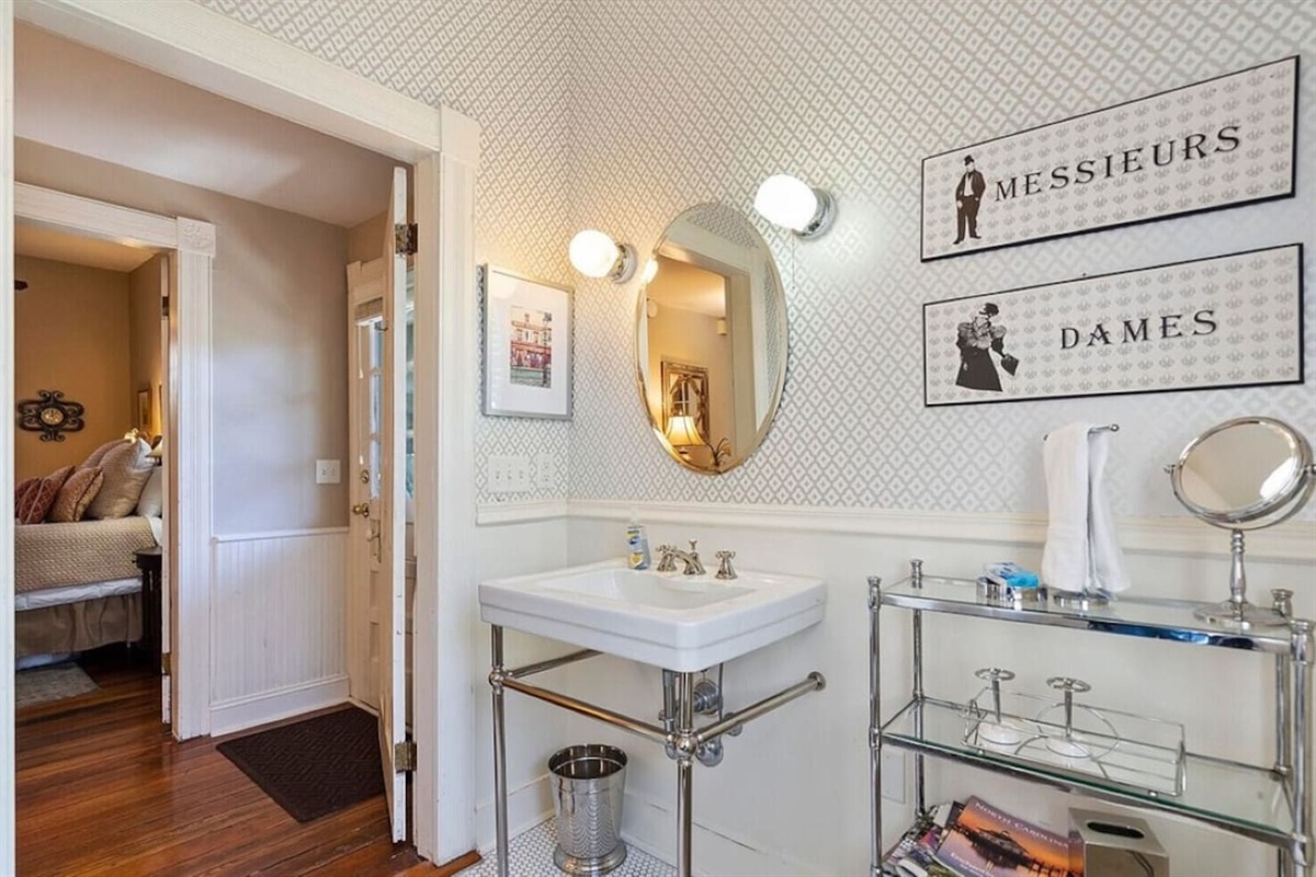 Spacious full-size bathroom with a magnifying mirror and hair dryer.