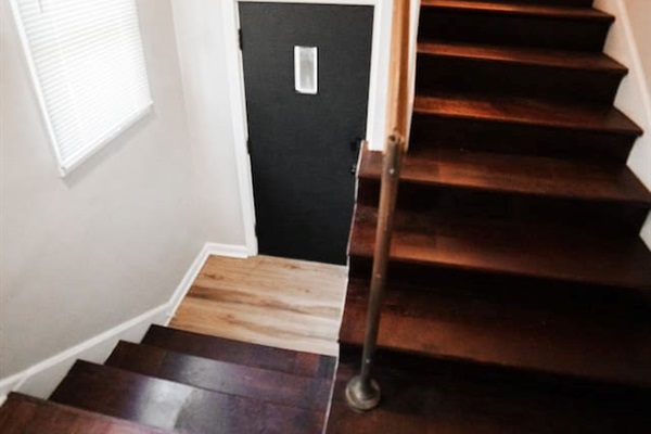 Stairs that lead upstairs to unit.