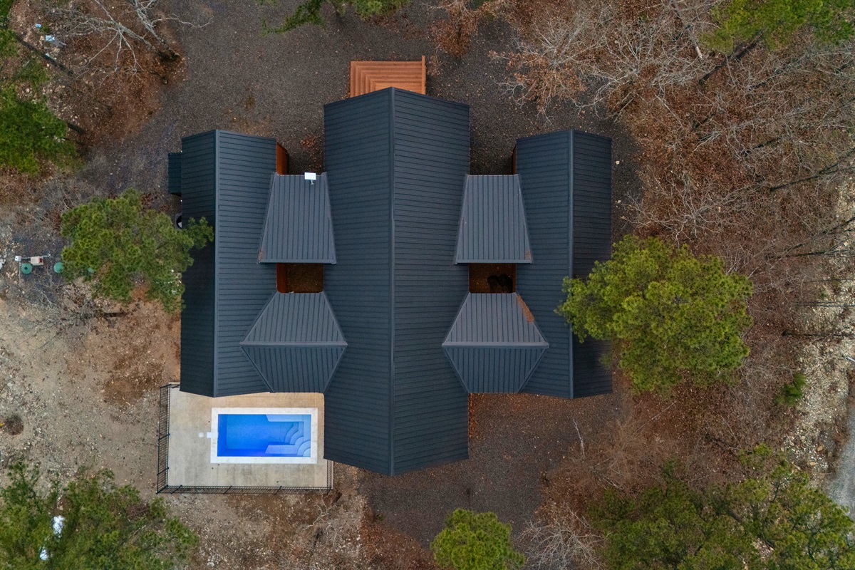 From above, you can see the full layout of the property, with the cabin and private pool nestled comfortably within the natural forest landscape.