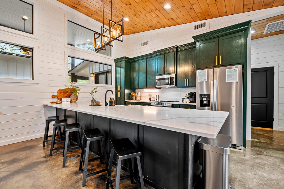 Gather around for great conversation and delicious meals in this spacious kitchen, complete with a modern touch.