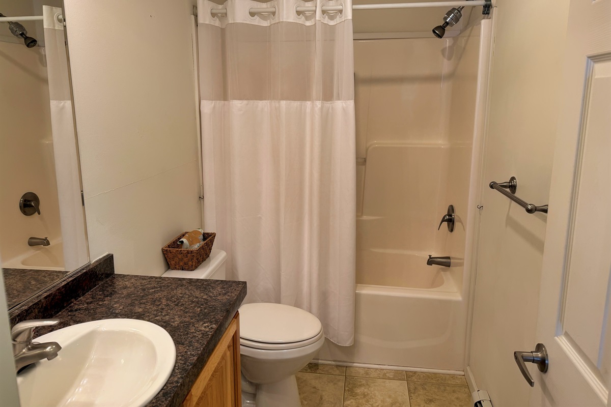 Hallway bathroom with tub/shower.