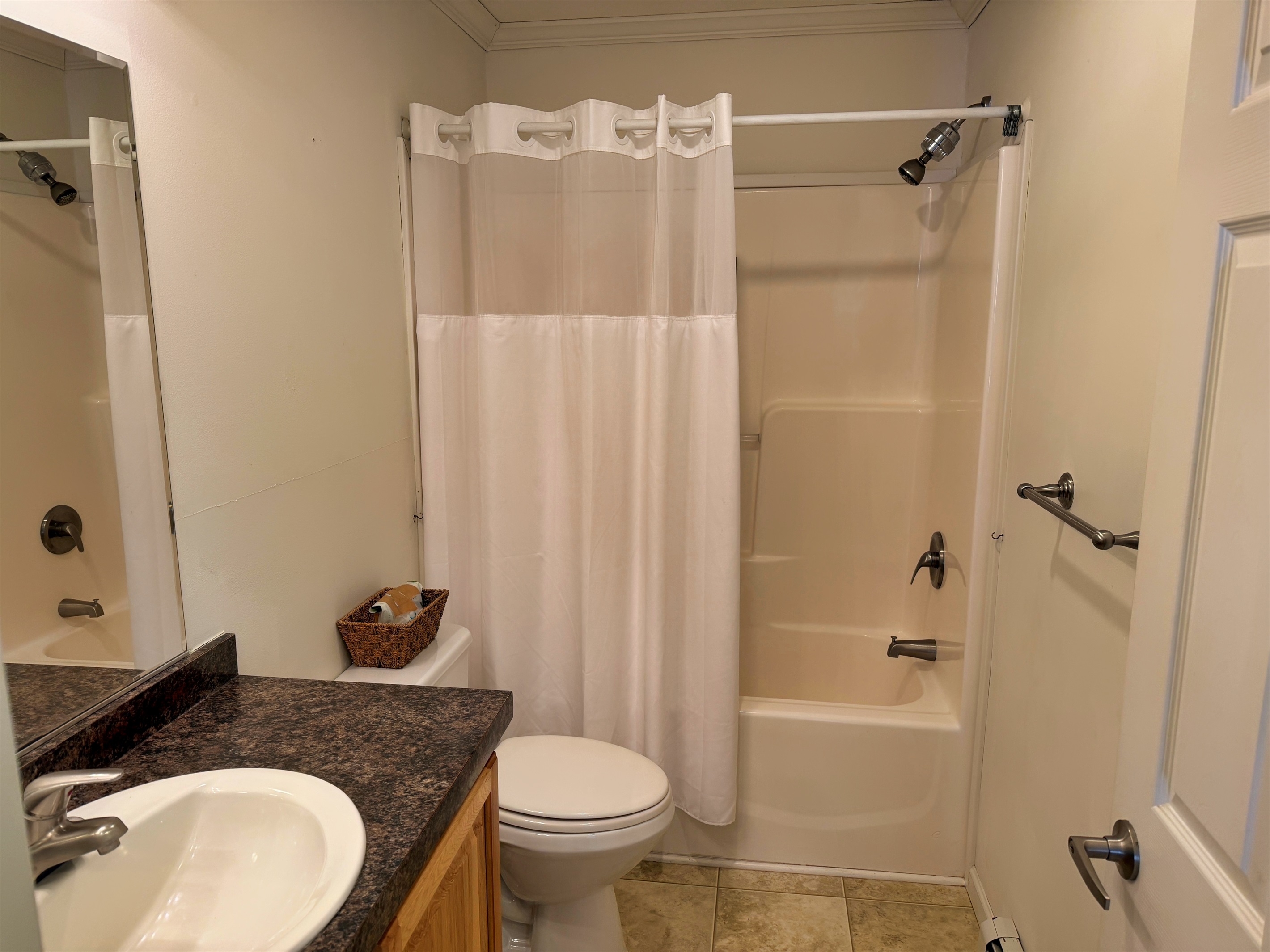 Hallway bathroom with tub/shower.