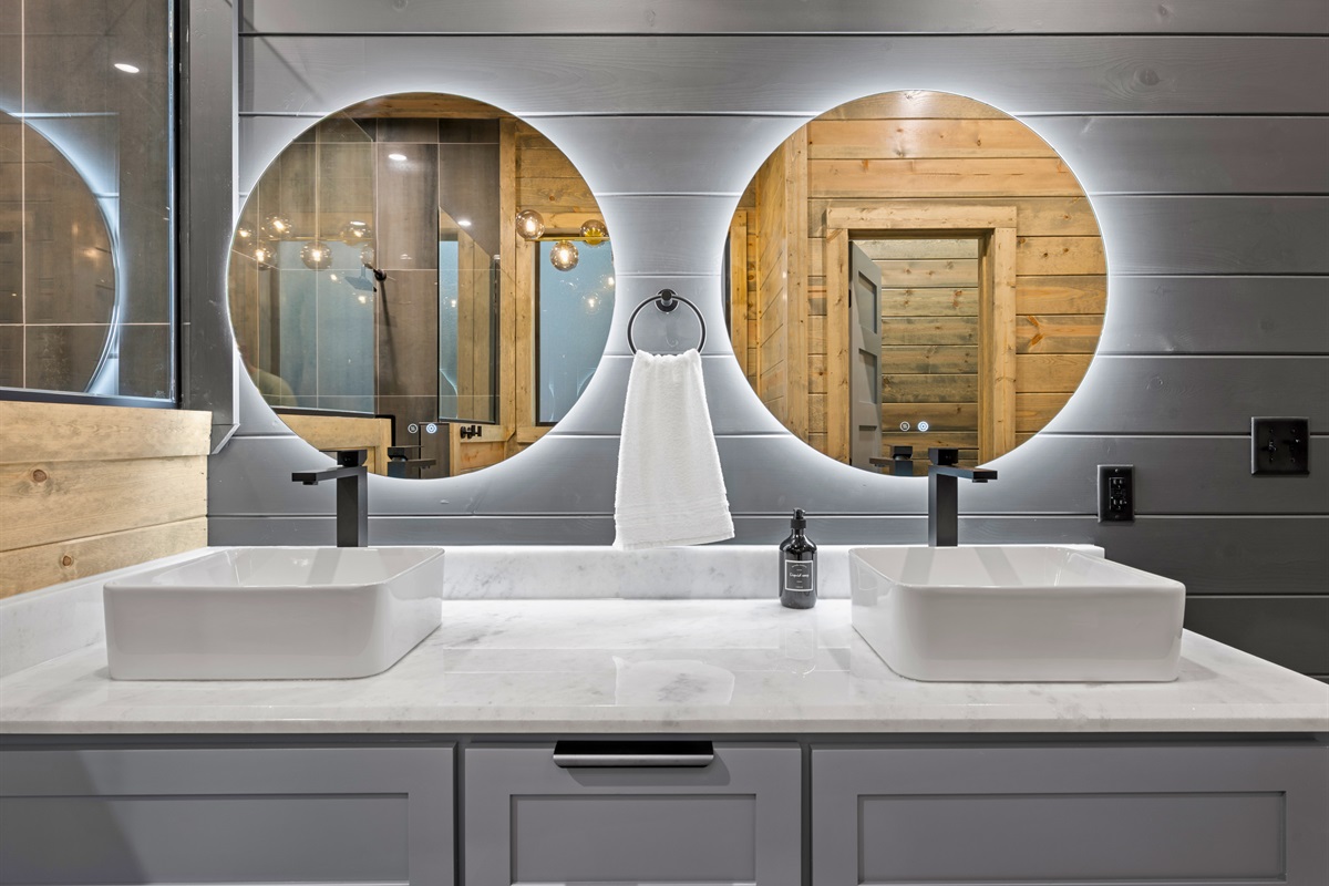 Two sinks and sleek round mirrors make this double vanity perfect for getting ready together without feeling crowded.