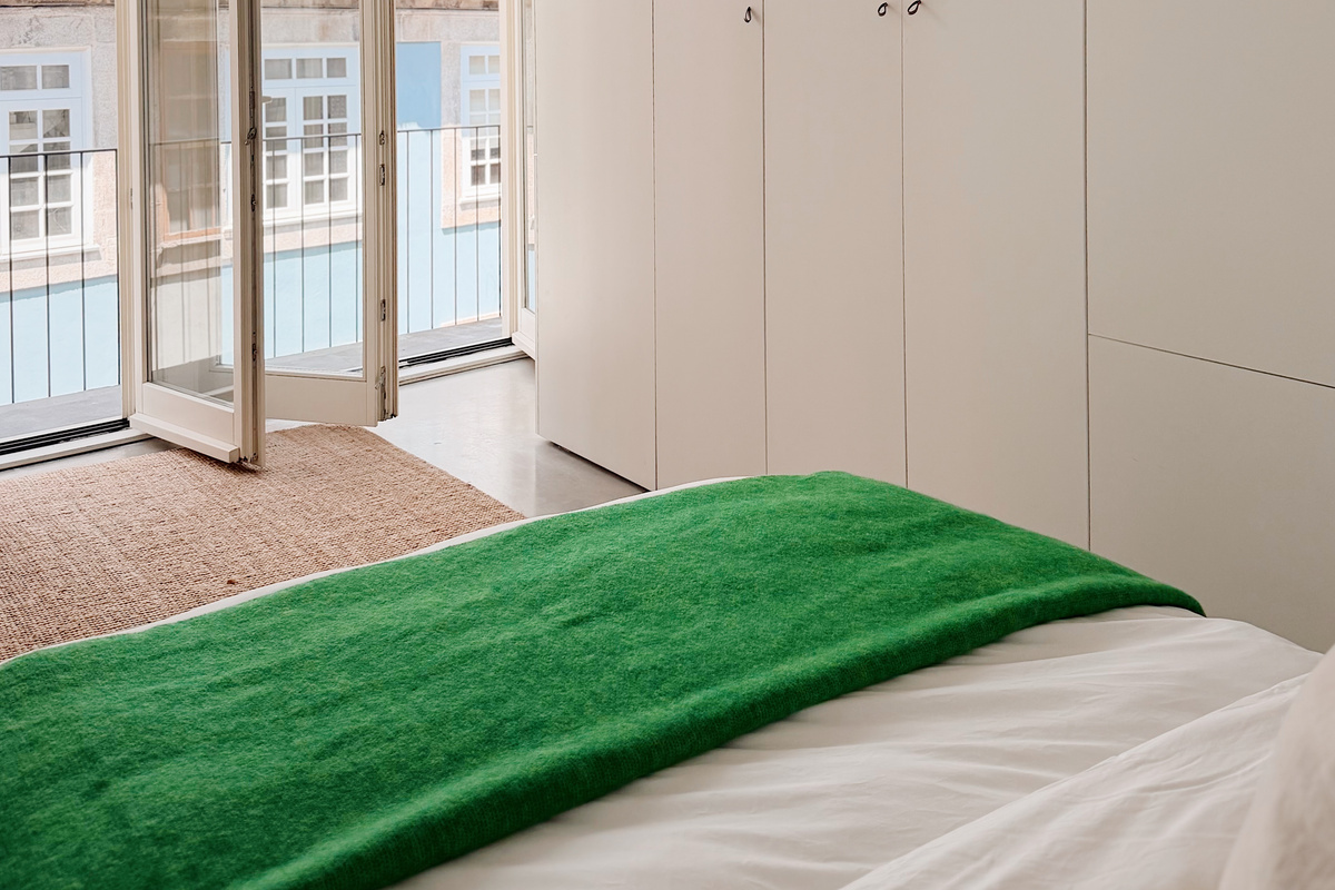 Balcony doors open in the bedroom area.