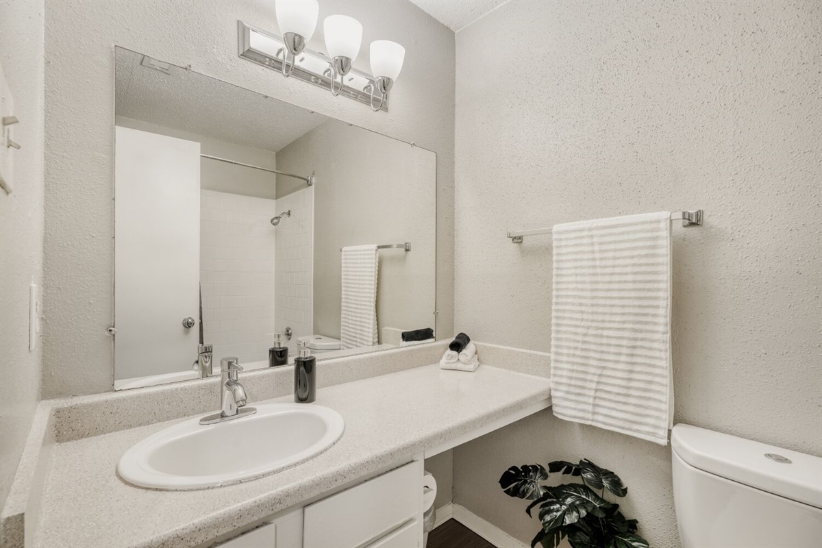 Bright and clean bathroom with a spacious vanity and modern lighting.