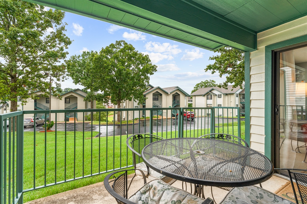 The patio looks onto a green courtyard that keeps the setting calm and residential.