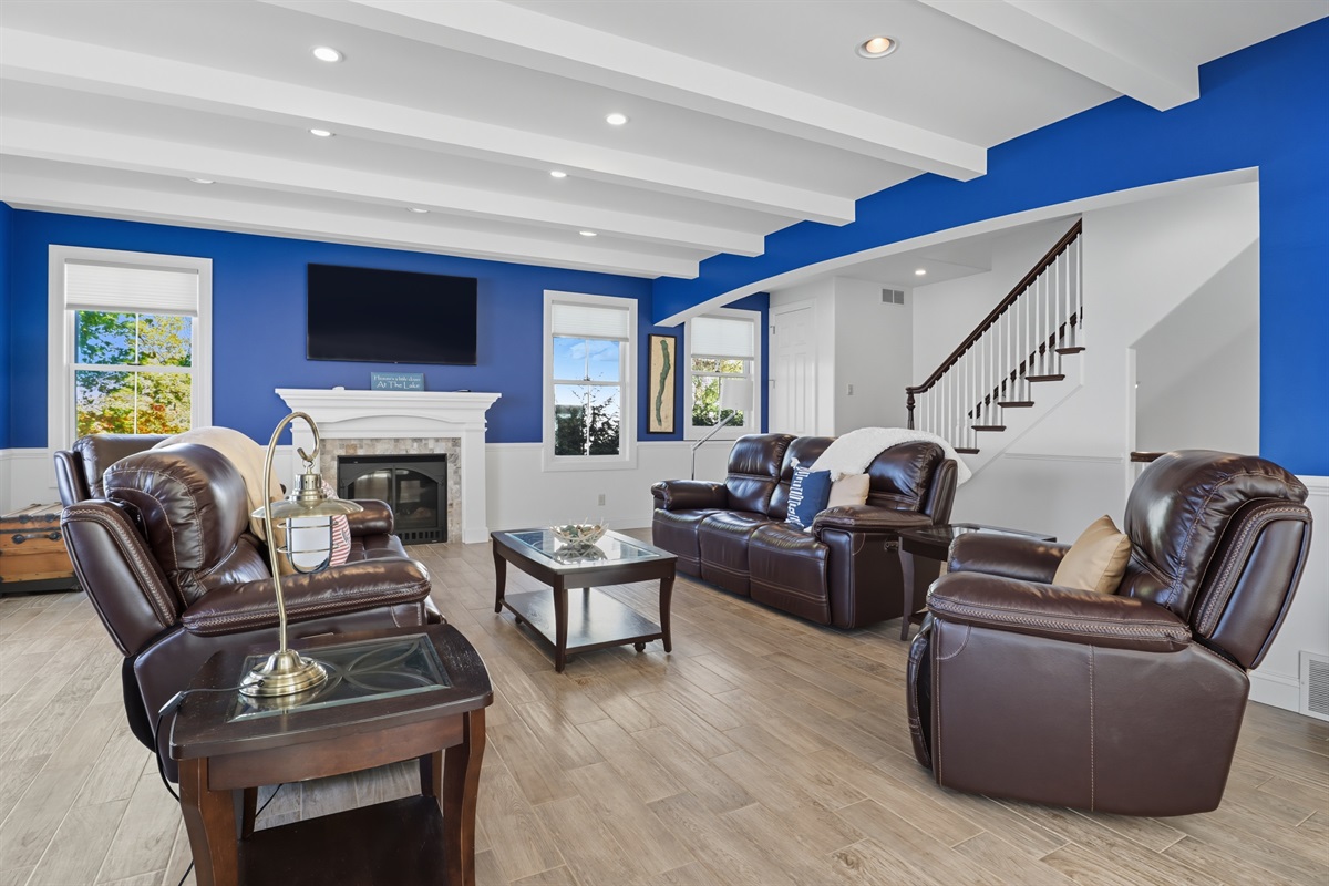 Spacious main floor living room with high ceilings, gas fire place and abundant natural light.