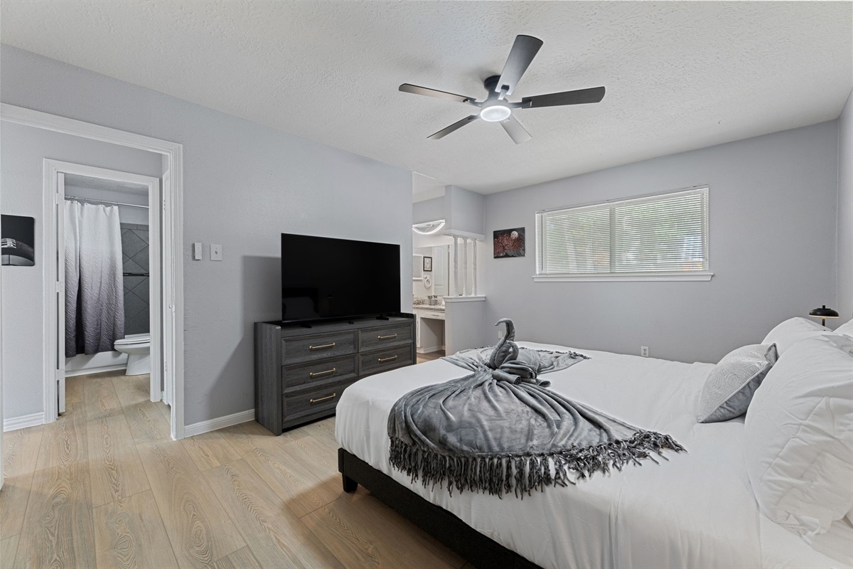 Retreat to the luxurious master suite with a king bed, private bath, and TV for ultimate comfort and privacy.