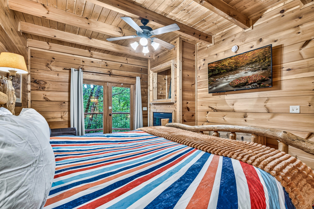 Unwind in bed with a movie, a warm fireplace, and french doors opening straight to nature.