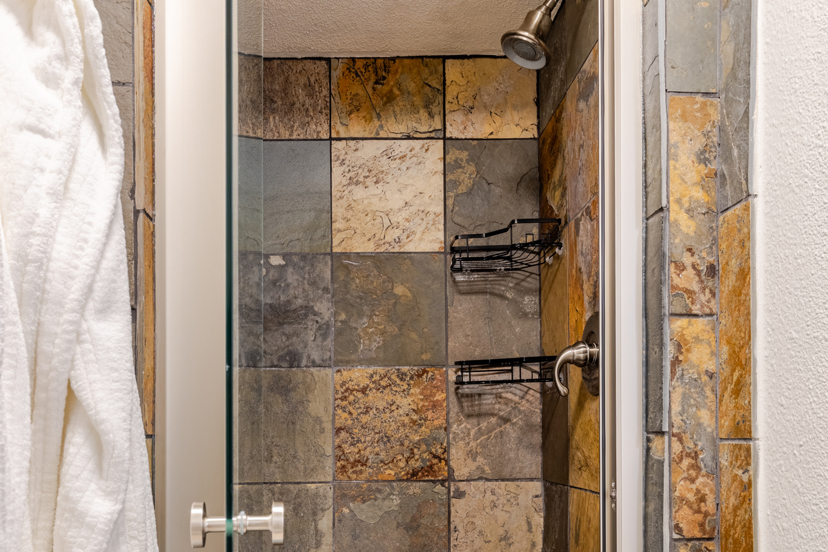 Step into a stunning stone oasis for refreshing rain shower experiences!