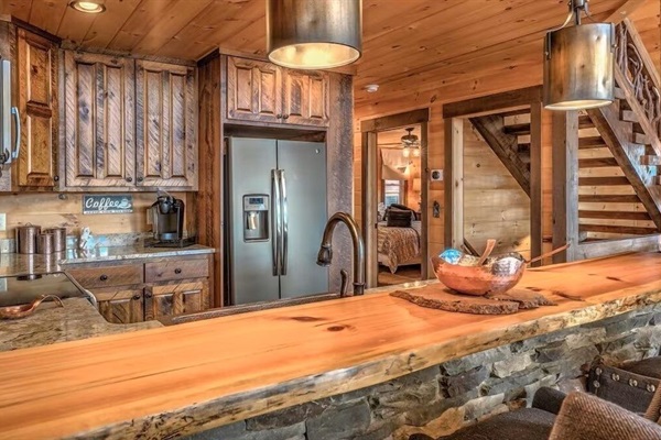 Rustic-luxury kitchen with custom wood cabinetry, stone countertops, and modern appliances - perfect for cooking and entertaining.