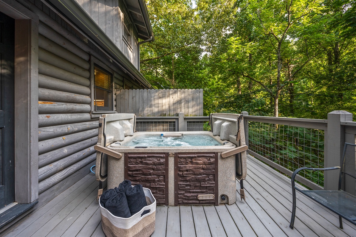 Unwind in the private hot tub, surrounded by serene nature.