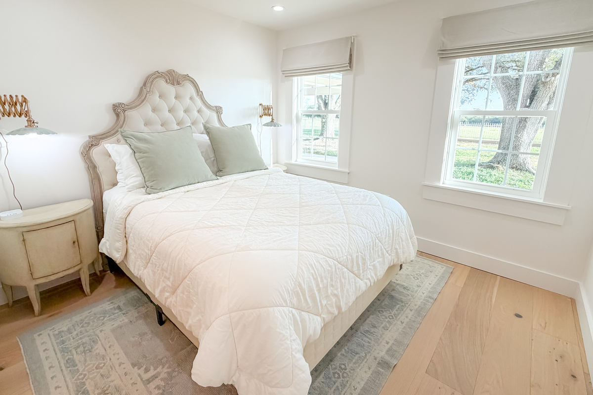 Bright and inviting main bedroom with a queen bed and natural light.