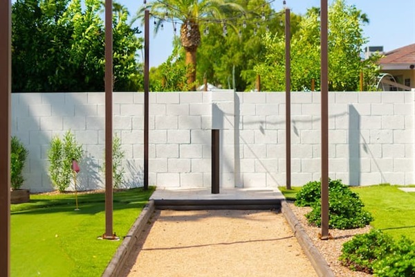 Stroll along the scenic outdoor walkway by the mini golf course, perfect for a cozy backyard event or intimate wedding. A beautiful setting for special moments!