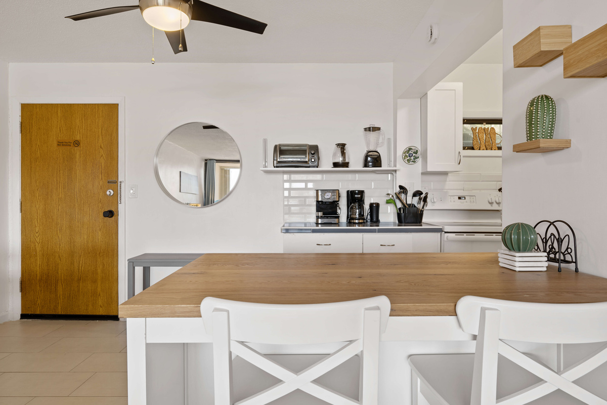 Coffee bar with a drip coffee maker, espresso maker, and a whole bean grinder.