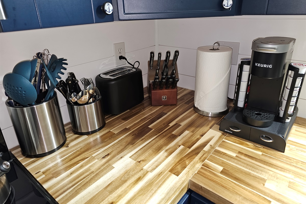 Fully equipped kitchen corner with Keurig, knives, toaster, and every utensil you’ll need for cooking