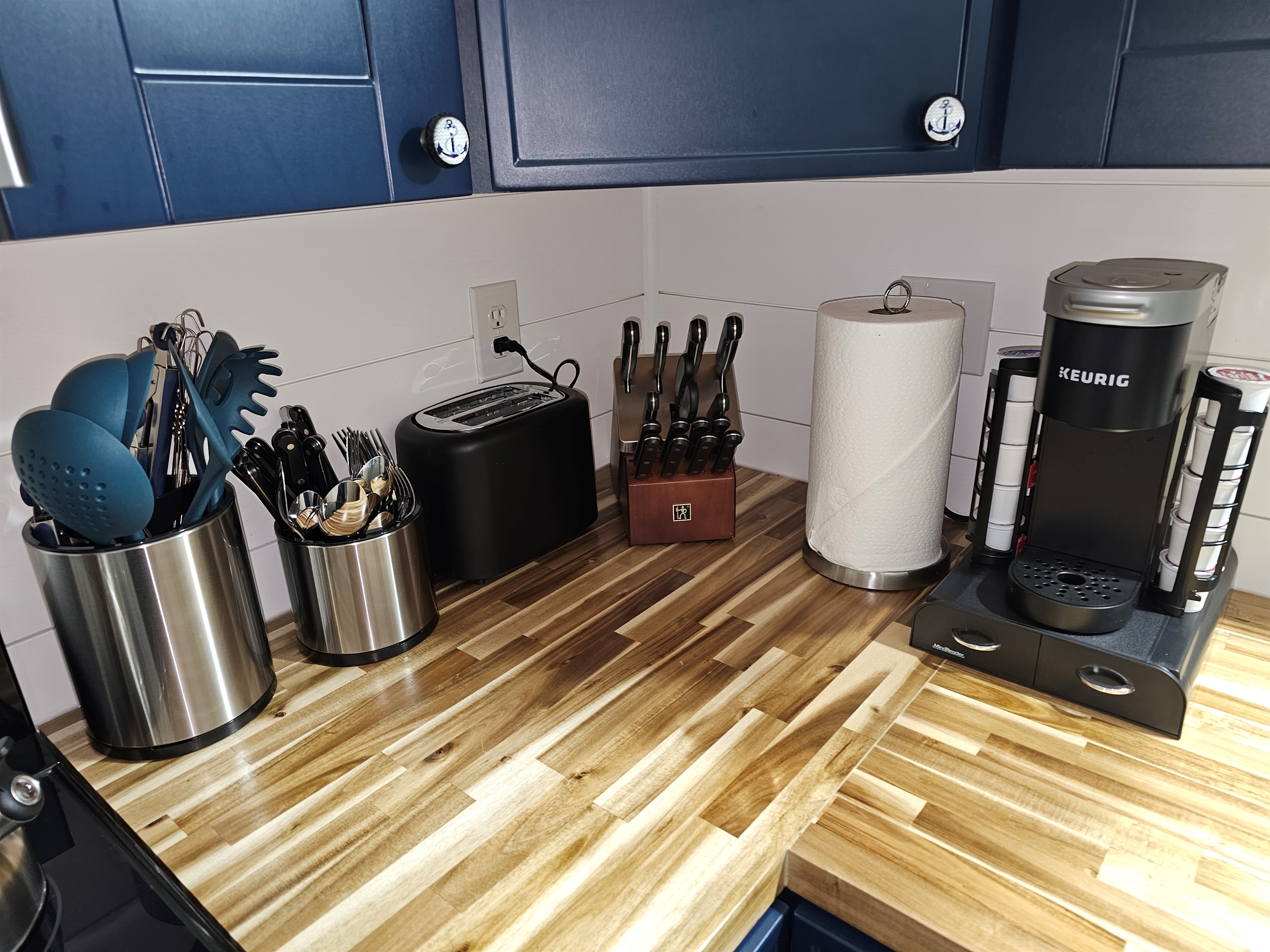Fully equipped kitchen corner with Keurig, knives, toaster, and every utensil you’ll need for cooking