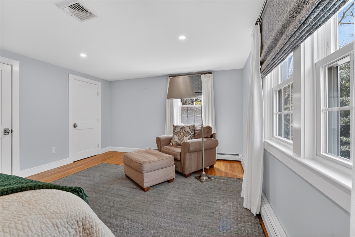 The third bedroom blends comfort and charm with a queen bed and a relaxing solo couch!