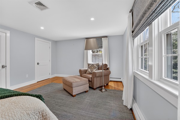 The third bedroom blends comfort and charm with a queen bed and a relaxing solo couch!